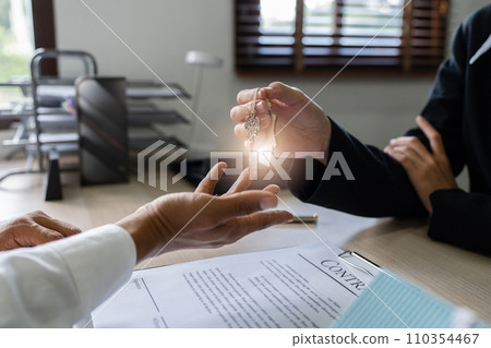 Real estate agent give the customer the keys after signing contract success with Home Loan and Home Insurance in the Office Real estate agent give the customer the keys after signing contract success with Home Loan and Home Insurance in the Office 110354467