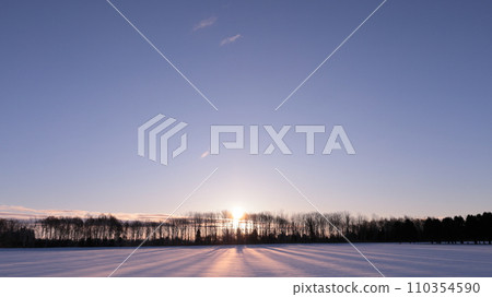 The morning sun rises over the snowy field in Eniwa City, Hokkaido The morning sun rises over the snowy field in Eniwa City, Hokkaido 110354590