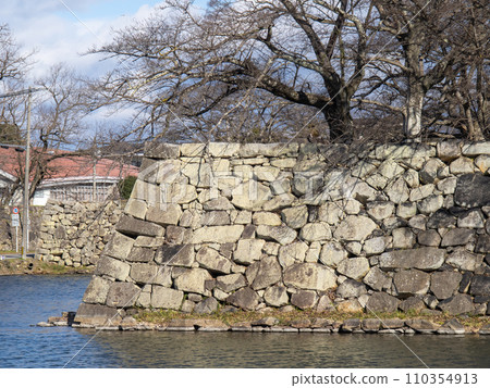 The stone walls and middle moat of Hikone Castle. Photographed in December from Shiga Prefectural Route 25 Hikone Omihachiman Line. The stone walls and middle moat of Hikone Castle. Photographed in December from Shiga Prefectural Route 25 Hikone Omihachiman Line. 110354913
