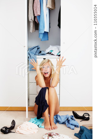 Frustrated, screaming woman and clothes in wardrobe on floor in home or house. Anger, stress and shouting person by closet with choice, fashion decision and tired of chaos in messy bedroom laundry 110355014