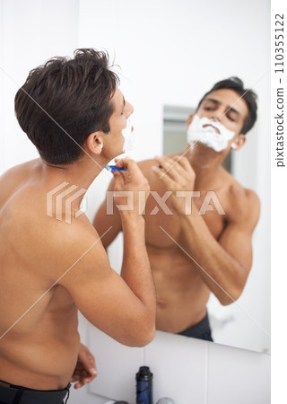 Man, shaving cream and blade in mirror for hair removal in bathroom, beauty and wellness. Male person, skincare and cosmetics or cleaning in morning routine, grooming and razor in reflection at home 110355122