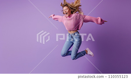 Cheerful Z generation blonde Japanese girl jumping and dancing isolated on purple background 110355123