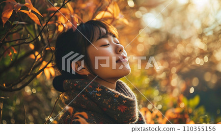 Young Japanese woman relaxing outdoors Young Japanese woman relaxing outdoors 110355156