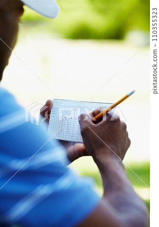 Sports, golf and person with scorecard on course with sheet for playing game, practice and training. Professional golfer, grass and hands writing score on paper for winning stroke for competition Sports, golf and person with scorecard on course with sheet for playing game, practice and training. Professional golfer, grass and hands writing score on paper for winning stroke for competition 110355323