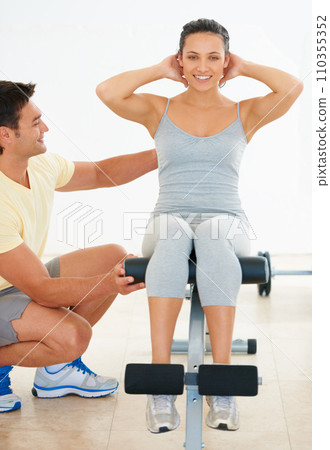 Personal trainer, woman and gym machine for crunch and fitness workout. Instructor, coach and healthy people with exercise equipment for strong body and athletic training for active lifestyle Personal trainer, woman and gym machine for crunch and fitness workout. Instructor, coach and healthy people with exercise equipment for strong body and athletic training for active lifestyle 110355352