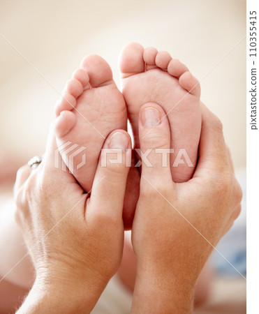 Feet, baby and closeup of hands of mother in a house with love, care and support, nurture and protection. Family, zoom and toes of kid with parent at home for child development, bonding and comfort 110355415