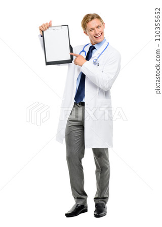 I just need you to sign this form. Full length shot of a handsome young doctor standing alone in the studio and pointing at a clipboard. 110355652