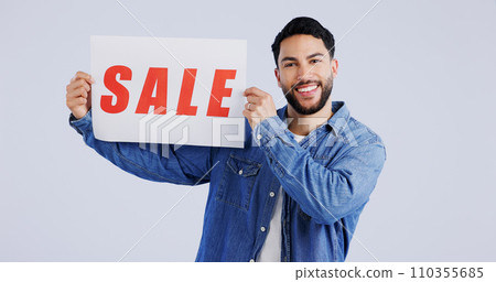 Happy man, portrait and sale sign for discount, promotion or banner against a gray studio background. Male person or model smile with billboard or poster for advertising or marketing store promo Happy man, portrait and sale sign for discount, promotion or banner against a gray studio background. Male person or model smile with billboard or poster for advertising or marketing store promo 110355685