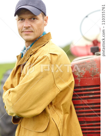 I help provide your fruit and veg - Farmer. Portrait of a farmer with his arms crossed while leaning against the hood of his tractor. I help provide your fruit and veg - Farmer. Portrait of a farmer with his arms crossed while leaning against the hood of his tractor. 110355761