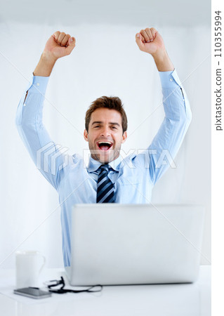 Business man, winner and computer for trading success, achievement or winning of bonus, sales or profit. Excited portrait of a trader with fist, yes and celebration on laptop and a white background Business man, winner and computer for trading success, achievement or winning of bonus, sales or profit. Excited portrait of a trader with fist, yes and celebration on laptop and a white background 110355994