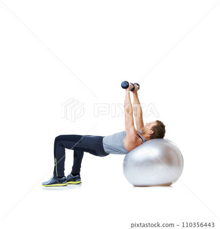 Fitness, exercise ball or man with dumbbell in studio for abs, core or balance challenge on white background. Workout, weightlifting or male bodybuilder with inflatable for wellness or sports routine Fitness, exercise ball or man with dumbbell in studio for abs, core or balance challenge on white background. Workout, weightlifting or male bodybuilder with inflatable for wellness or sports routine 110356443
