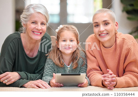 Little girls rule the world. Portrait of a mature woman bonding with her daughter and granddaughter while using a digital tablet. Little girls rule the world. Portrait of a mature woman bonding with her daughter and granddaughter while using a digital tablet. 110356444