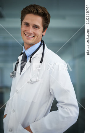 Smile, pride and portrait of man doctor with stethoscope for positive, good and confident attitude. Happy, career and professional young male healthcare worker in medical office of hospital or clinic 110356744