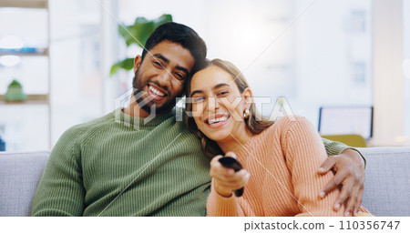 Couple, watching tv and remote on living room couch with smile, hug or relax with click for choice, show or film. Man, woman and happy together for embrace, movie or streaming on lounge sofa in home 110356747