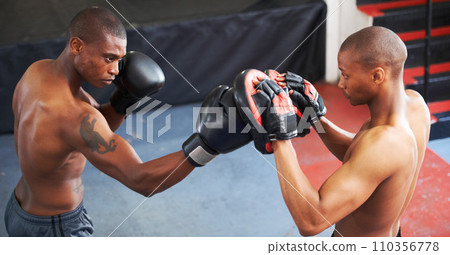 Boxing, coaching and black man with personal trainer for support, power or training challenge. Strong body, sparring partner and boxer in gym with fist up, workout and confidence in competition fight Boxing, coaching and black man with personal trainer for support, power or training challenge. Strong body, sparring partner and boxer in gym with fist up, workout and confidence in competition fight 110356778