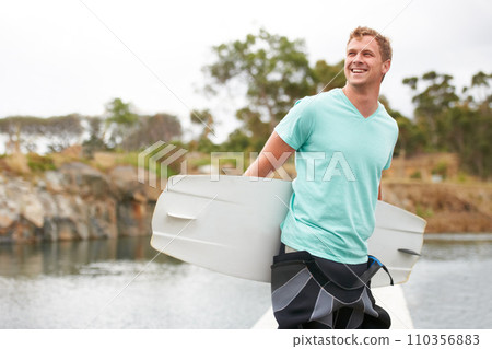 Sports, happy and man by lake with wakeboard for surfing, exercise and recreation hobby outdoors. Fitness, extreme sport and excited person with board for water skiing for freedom, adventure and fun 110356883