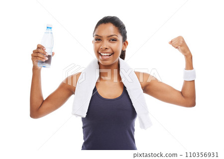 Woman, flexing muscles and fitness in studio, portrait and liquid for health and wellness. Athlete, female person and pride on face for strong biceps, water bottle and empowerment by white background 110356931