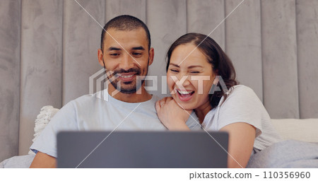 Laptop, happy and young couple in bed watching movie, film or show together at home. Smile, technology and man and woman relaxing in bedroom streaming a video on computer for bonding at modern house. Laptop, happy and young couple in bed watching movie, film or show together at home. Smile, technology and man and woman relaxing in bedroom streaming a video on computer for bonding at modern house. 110356960