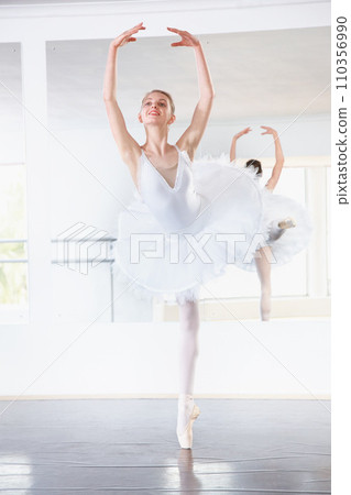 Smile, dance and teen student in ballet studio with pose, balance and performance class for teenager. Movement, talent and young ballerina dancer with pride, confidence and creative show at academy. 110356990