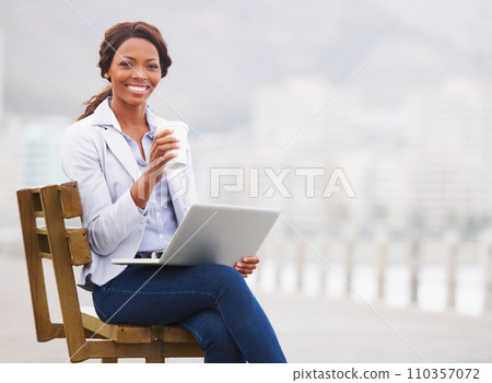Black business woman, coffee and laptop on bench, promenade and portrait with smile, drink and beach. Entrepreneur, happy and outdoor with tea cup, computer and nature by ocean with fog in Cape Town 110357072