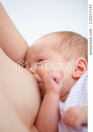 Closeup, woman and baby for breastfeeding in home for hunger, food and wellness in health. Love, bonding and relationship in motherhood with nutrition in childcare for growth, development and future Closeup, woman and baby for breastfeeding in home for hunger, food and wellness in health. Love, bonding and relationship in motherhood with nutrition in childcare for growth, development and future 110357143