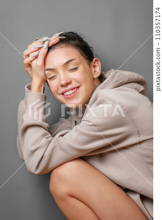 Portrait of a young pretty girl in a hoodie Portrait of a young pretty girl in a hoodie 110357174