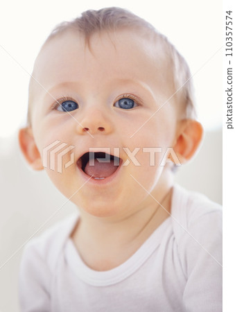 Home, happy and face of baby relax, resting and calm in nursery for sleeping or wake up in morning. Family, youth and closeup of infant newborn in bedroom for child development, growth and wellness 110357574