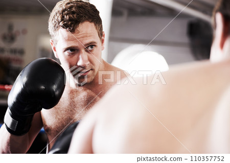 Fight, man and boxer in ring with confidence for fitness, power strike or workout training challenge. Strong hit, boxing and athlete in gym with personal trainer, action and fearless in competition. Fight, man and boxer in ring with confidence for fitness, power strike or workout training challenge. Strong hit, boxing and athlete in gym with personal trainer, action and fearless in competition. 110357752