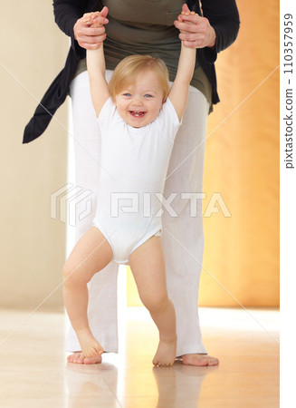 Baby, mother and learning to walk with holding hands, happiness and growth for child development in home. Toddler, kid and woman with parenting, support and helping for nurture, guiding and love 110357959