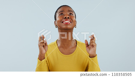 Hope, wish and black woman in studio with fingers crossed for opportunity, deal or good news prayer. Praying hands, thinking and person with winning dream, confidence and faith on white background. 110358505