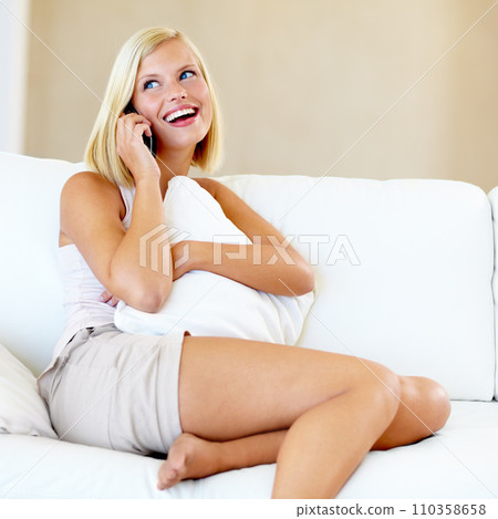 Relax, smile and woman on sofa with phone call, conversation and connectivity in home. Networking, happy discussion and girl on couch talking on smartphone chat in living room with communication. Relax, smile and woman on sofa with phone call, conversation and connectivity in home. Networking, happy discussion and girl on couch talking on smartphone chat in living room with communication. 110358658