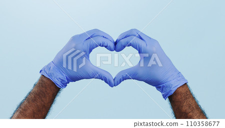 Man, doctor and heart hands with gloves for healthcare isolated against a blue studio background. Closeup of male person or medical nurse with like emoji, yes sign or shape for love or care on mockup Man, doctor and heart hands with gloves for healthcare isolated against a blue studio background. Closeup of male person or medical nurse with like emoji, yes sign or shape for love or care on mockup 110358677