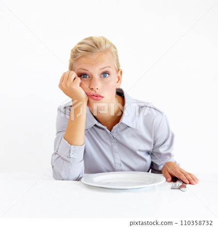 Hungry, portrait and woman with a plate in a studio with upset, frustrated and grumpy face. Bored, moody and young female person from Australia with dish and cutlery isolated by white background. Hungry, portrait and woman with a plate in a studio with upset, frustrated and grumpy face. Bored, moody and young female person from Australia with dish and cutlery isolated by white background. 110358732