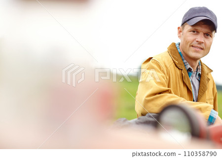 Hes a confident farmer. Portrait of a farmer standing outside beside blurred copyspace. Hes a confident farmer. Portrait of a farmer standing outside beside blurred copyspace. 110358790