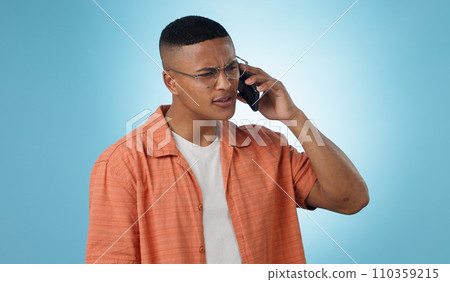 Man, confused and cellphone in studio for call connection, bad signal or communication. Male person, mobile and internet chat social media or conversation web talking, blue background as mockup space 110359215