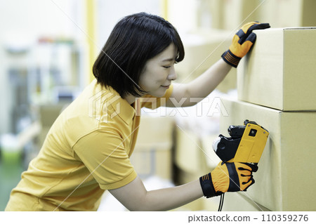 Female staff working at the distribution center 110359276