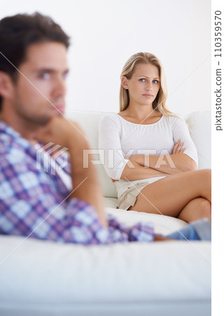 Woman, angry and living room couch with disagreement, upset and thinking with anger, fight or mad. Divorce, betrayal and relationship with cheating, stress and argument for marriage, home and man 110359570
