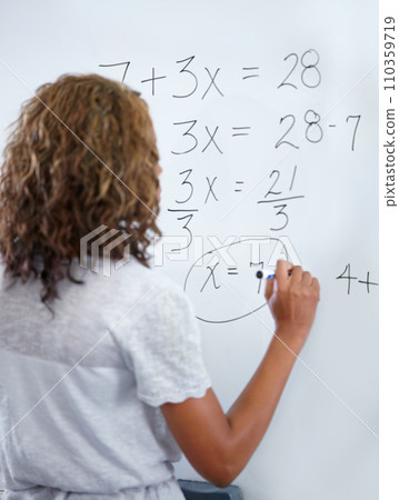Woman, teacher and writing on whiteboard for mathematics, numbers or equations in classroom. Rear view of female person, educator or lecturer with sum on board for learning or problem solving class Woman, teacher and writing on whiteboard for mathematics, numbers or equations in classroom. Rear view of female person, educator or lecturer with sum on board for learning or problem solving class 110359719