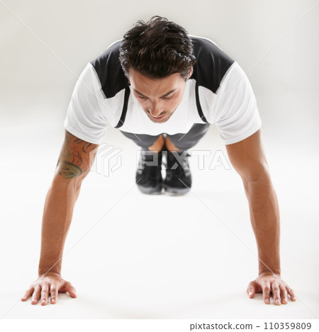 Fitness, push ups or sports man training in studio for muscle or strong arms on floor in exercise. Power, white background or healthy athlete in calisthenics for wellness, energy or body workout Fitness, push ups or sports man training in studio for muscle or strong arms on floor in exercise. Power, white background or healthy athlete in calisthenics for wellness, energy or body workout 110359809