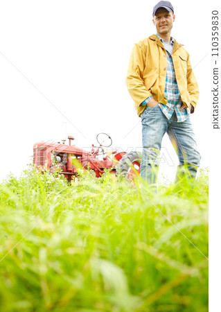 My average working day. Full length portrait of a farmer standing in a field with a tractor parked behind him - Copyspace. My average working day. Full length portrait of a farmer standing in a field with a tractor parked behind him - Copyspace. 110359830