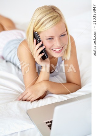 Relax, laptop and phone call with woman on bedroom for contact, communication and connection. Happy, digital and technology with female person in home for calm, listening and mobile conversation Relax, laptop and phone call with woman on bedroom for contact, communication and connection. Happy, digital and technology with female person in home for calm, listening and mobile conversation 110359947