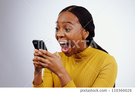 Woman, reading phone and wow for happy news, social media competition or giveaway success on a white background. African person with surprise, excited and shocked for mobile sale or bonus in studio 110360026