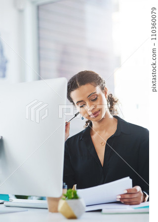 Work hard to make your dreams work. a young businesswoman going through paperwork while working in an office. 110360079