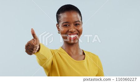Happy black woman, portrait and thumbs up in winning, success or good job against a gray studio background. African female person smile with like emoji, yes sign or thank you for approval or mockup 110360227