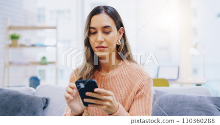 Woman, phone and home on living room sofa with reading, texting or typing for email, contact or web blog. Girl, smartphone and check notification for update, news or social media app on lounge couch 110360288