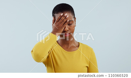 Frustrated black woman, headache and stress in mistake, fail or loss against a gray studio background. Face of tired African female person or model with migraine in disappointment, burnout or fatigue Frustrated black woman, headache and stress in mistake, fail or loss against a gray studio background. Face of tired African female person or model with migraine in disappointment, burnout or fatigue 110360320