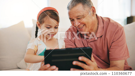 Home, grandfather and girl with tablet, internet and relax with social media, technology and digital app. Apartment, old man and pensioner with grandchild, happiness and online games with fun 110360677