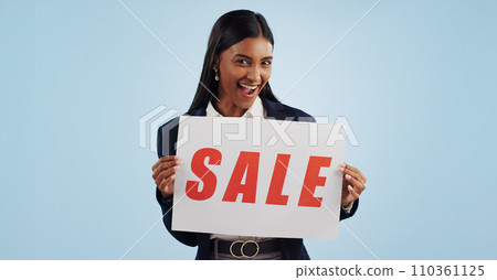 Happy woman, portrait and sale sign for discount, advertising or deal against a blue studio background. Excited female person with billboard or poster for marketing, promo or special on mockup space 110361125