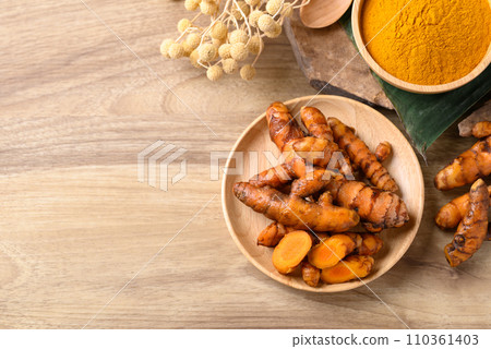 Fresh turmeric and powder, Spice in Asian cuisine, Table top view Fresh turmeric and powder, Spice in Asian cuisine, Table top view 110361403