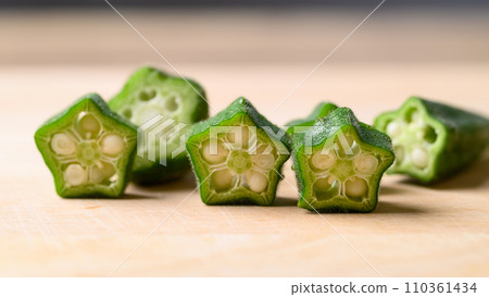 Sliced green okra on wooden board prepare for cooking, Organic vegetables Sliced green okra on wooden board prepare for cooking, Organic vegetables 110361434